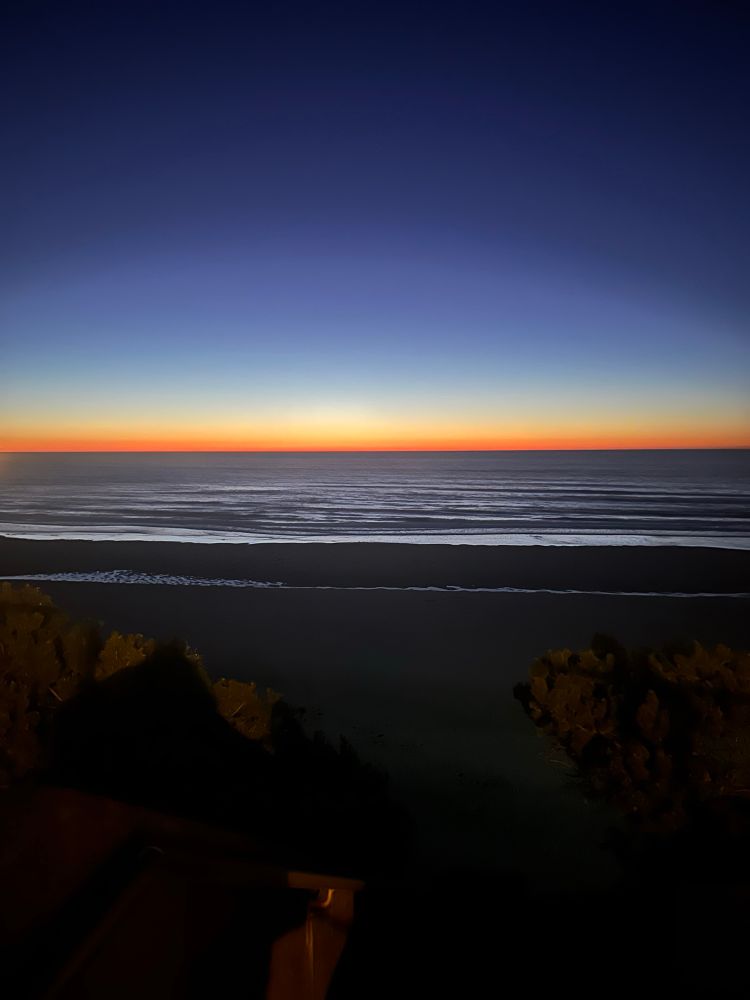 Picture of sunset over the beach and waves