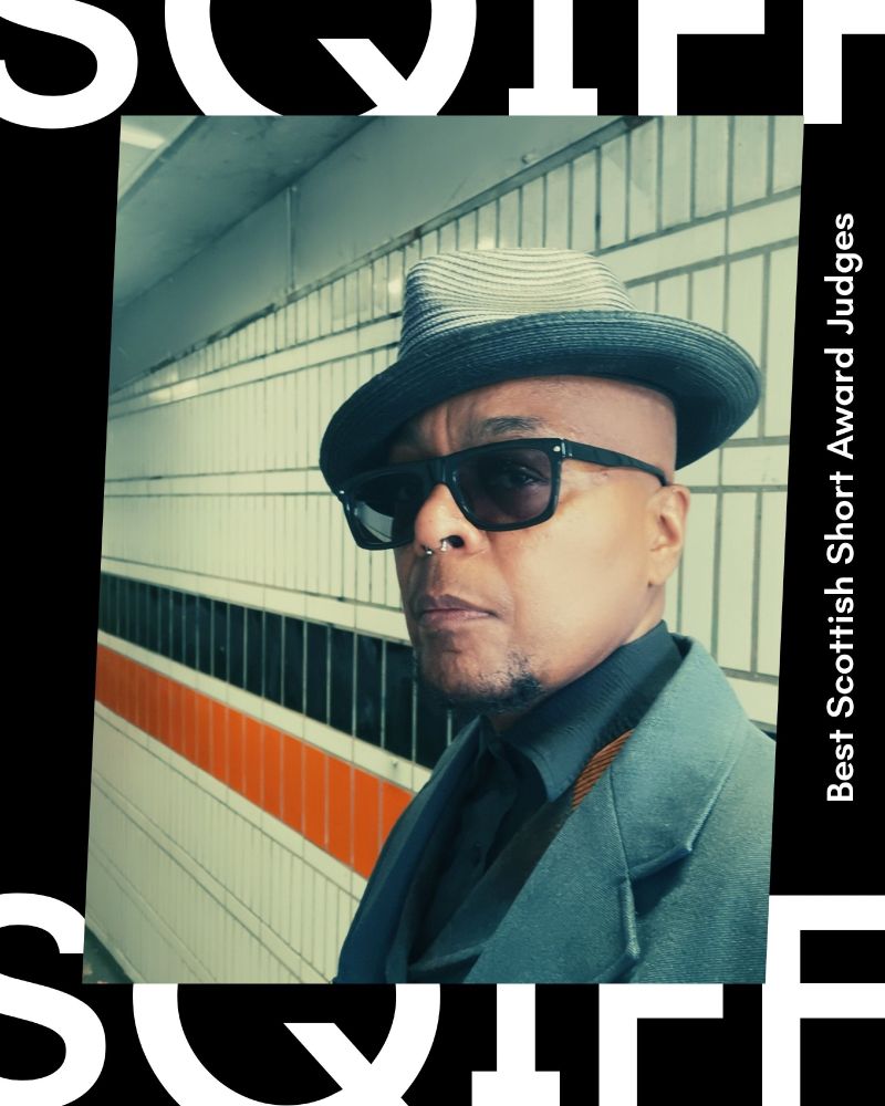 Close up shot of Campbell X, a black man wearing sunglasses and a hat.
