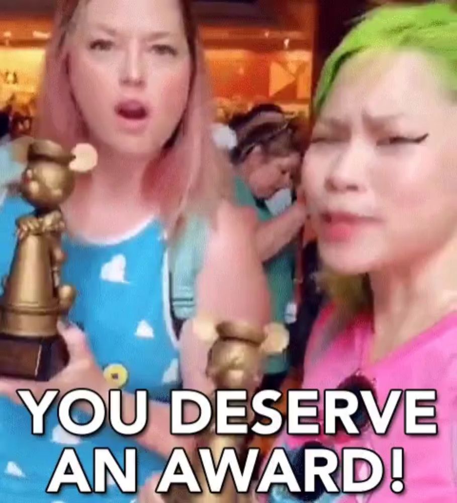 two women holding a trophy with the words you deserve an award