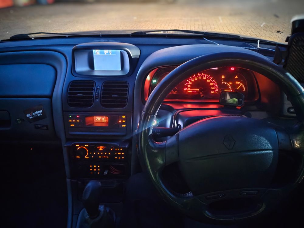 A car interior — a 1999 Renault Laguna 2.9 Monaco V6. As it's the early hours of the morning, it's illuminated.