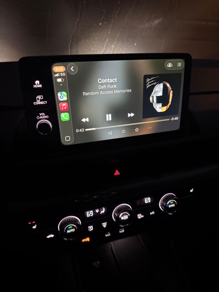 Dashboard of car, showing daft punk playing 